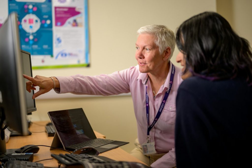 IT support helping an SME staff member with a computer issue