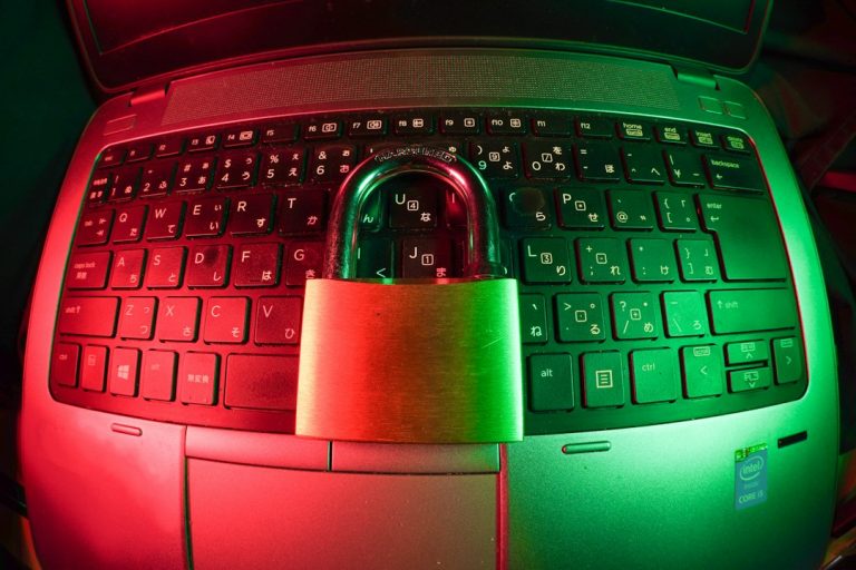 Padlock on a laptop keyboard, representing a ransomware attack